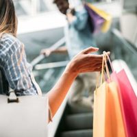 Happy attractive loving couple enjoy spending time in shopping together
